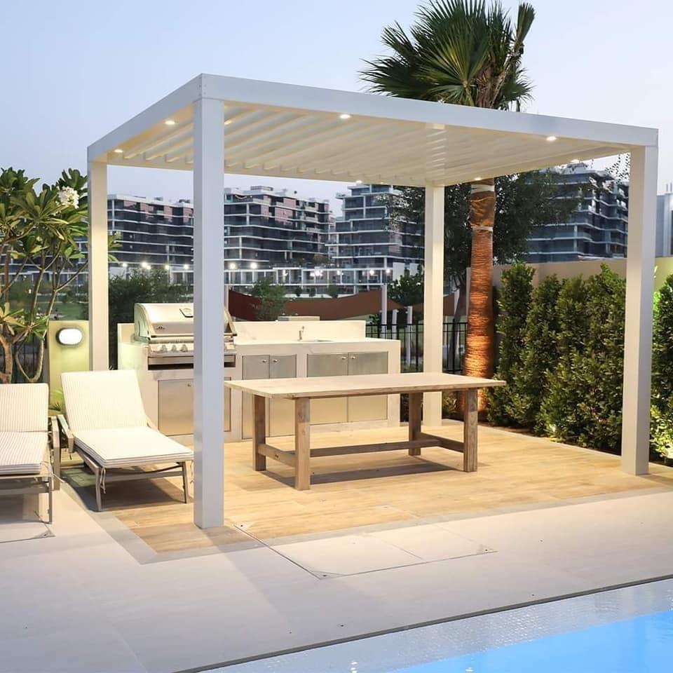 Louvered pergola with grill island — Dubai Hills poolside