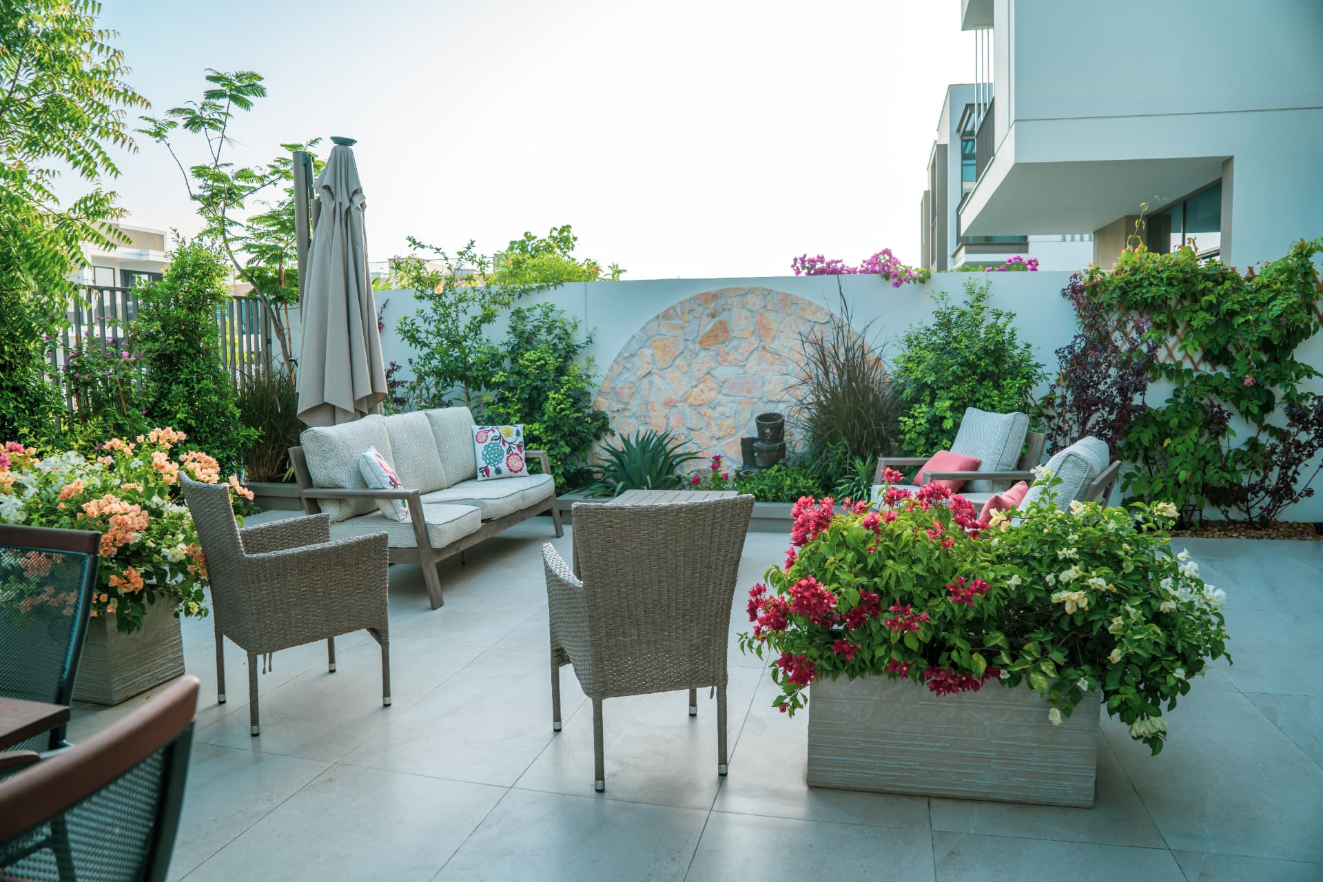 Pool terrace, planting and seating forming one outdoor environment at a Dubai villa