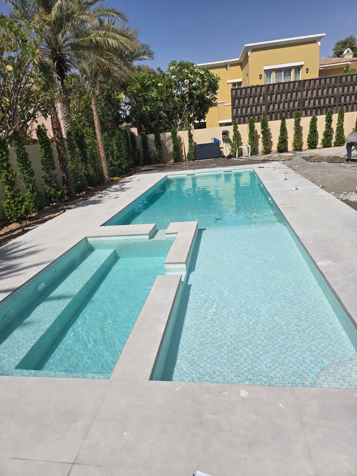 Mosaic tiled pool with sun ledge — Jumeirah Islands villa, built by Blue Iconic