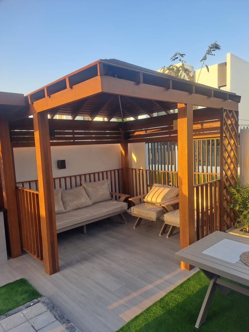 Hardwood gazebo lounge — Arabian Ranches garden, outdoor living project by Blue Iconic