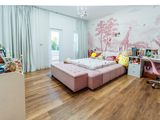 Children's bedroom with hand-painted mural wall and custom joinery