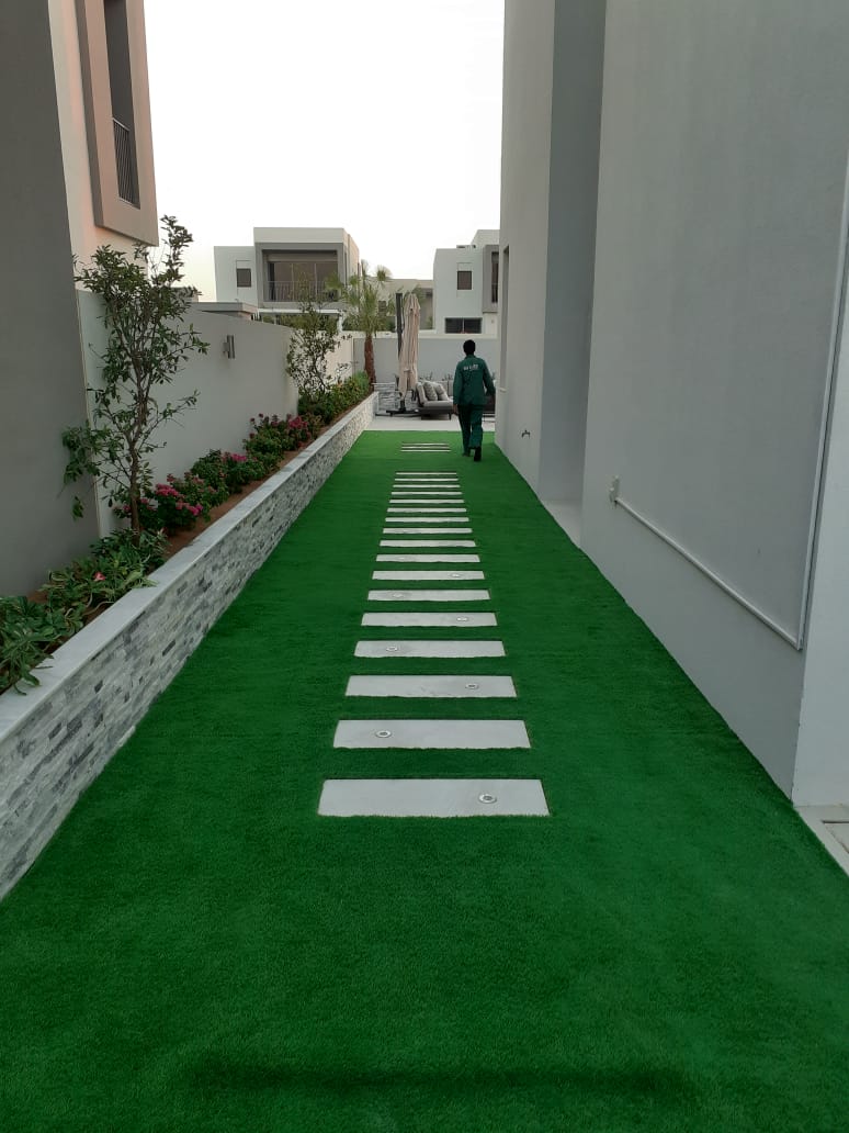 Side lawn walkway with uplights — Dubai Hills villa