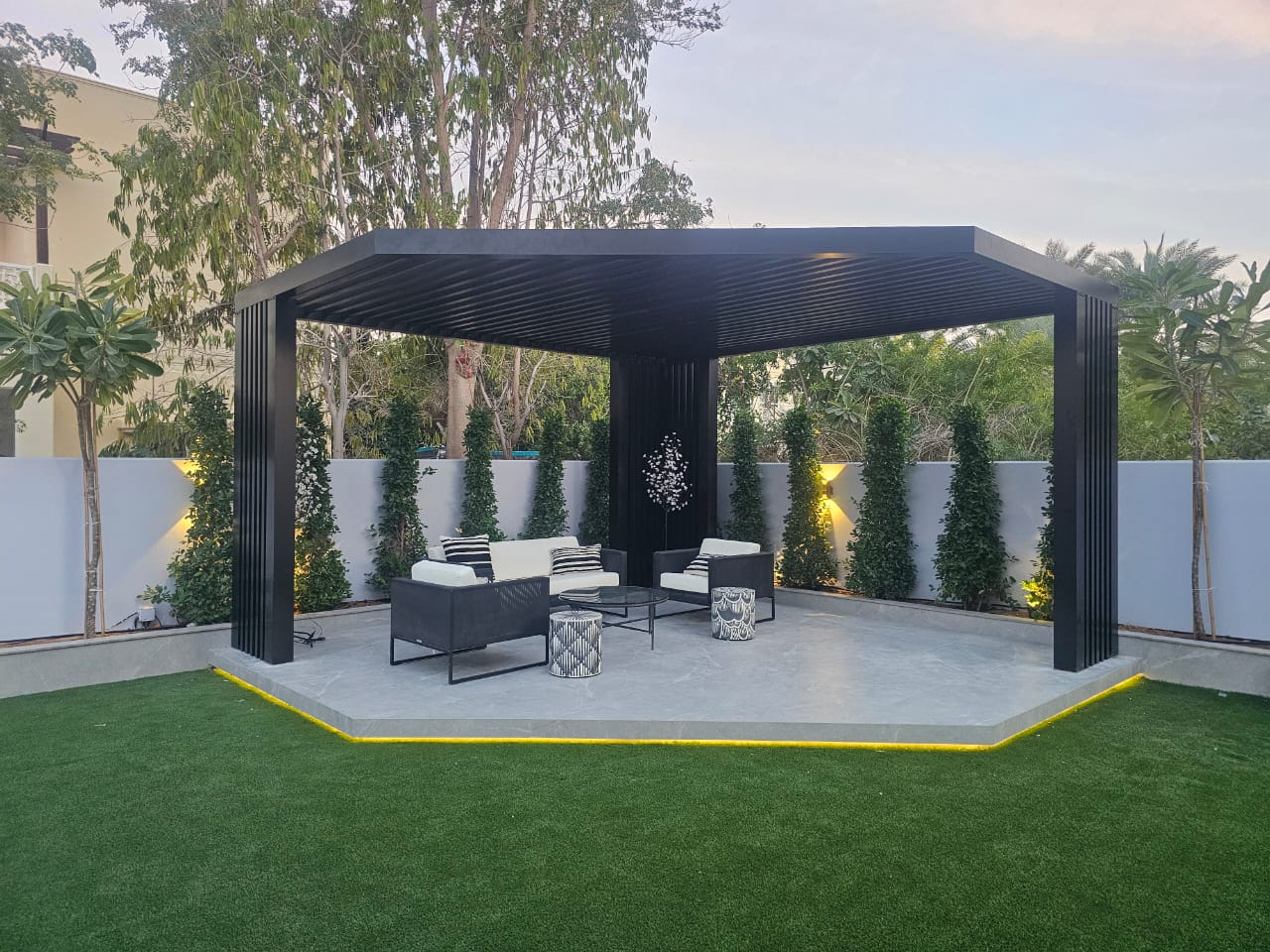 Black louvered pergola lounge — Jumeirah Golf Estates