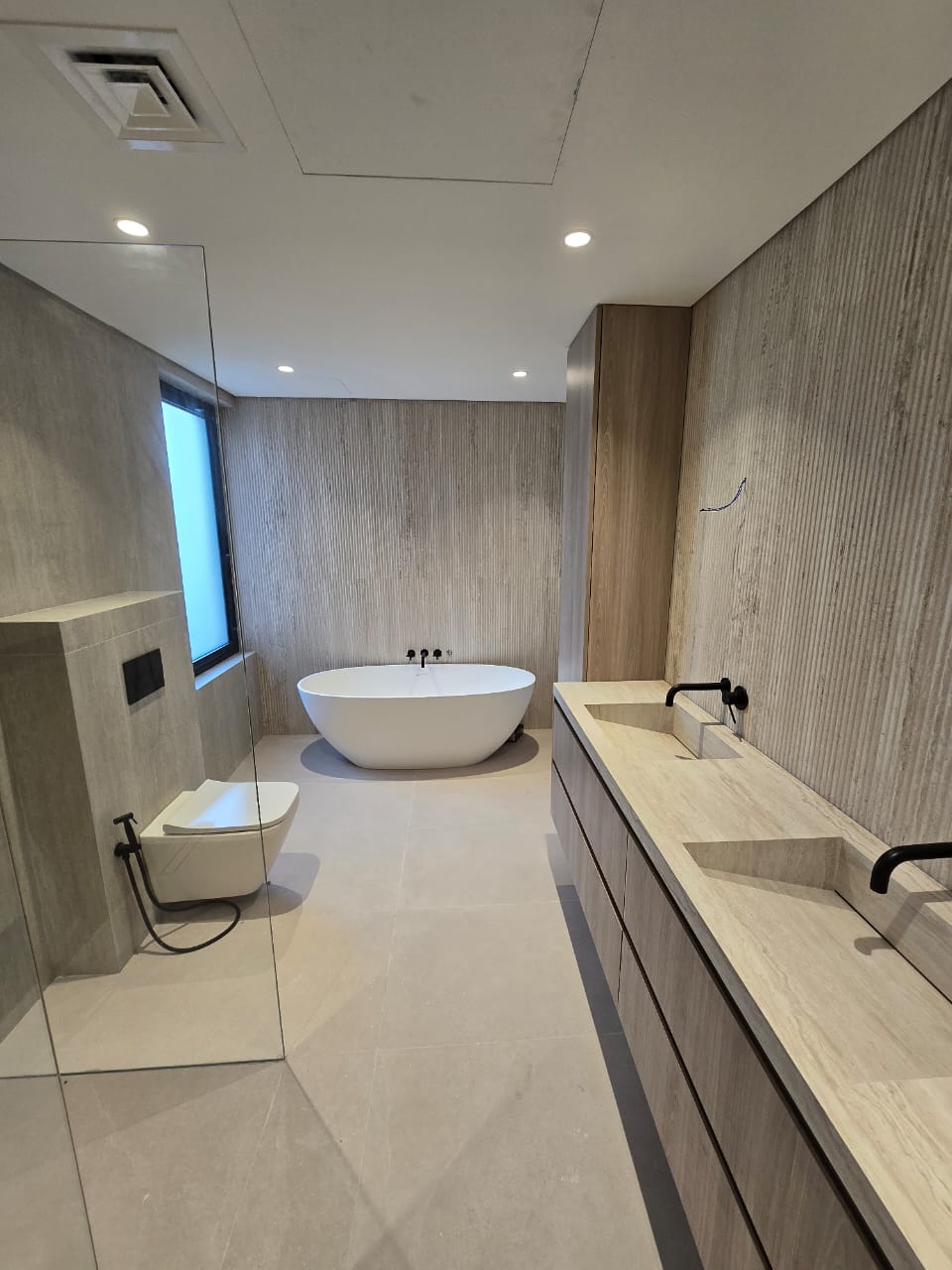 Travertine master bathroom — Palm Jumeirah villa