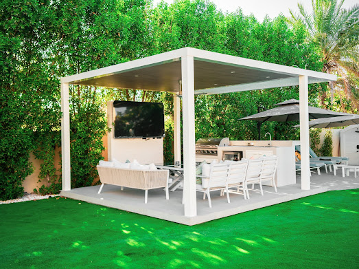 Pergola lounge with planting and paving connecting villa and garden in Dubai